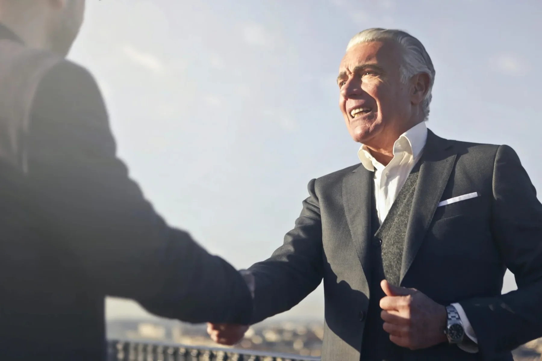 Two executives greeting one another in conversation