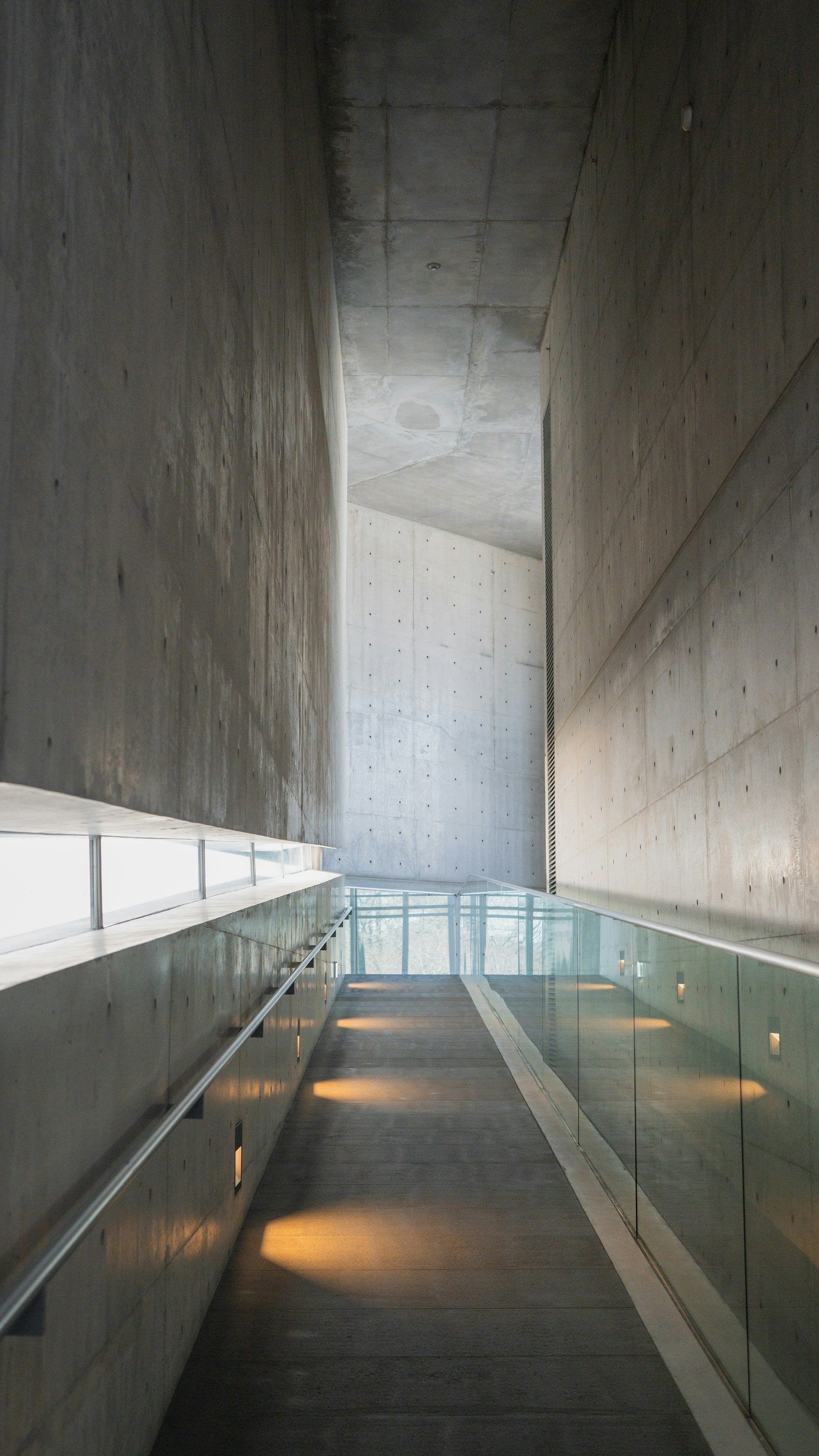 A restrained concrete passage shaped by light and shadow